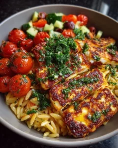Delicious Mediterranean Orzo Bowl with grilled halloumi and roasted tomatoes.
