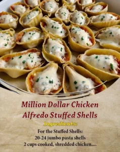 Creamy Million Dollar Chicken Alfredo Stuffed Shells topped with cheese and herbs.