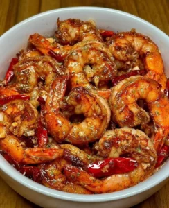 Plate of minute chili garlic glazed shrimp garnished with herbs