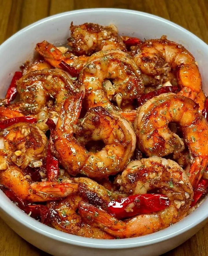 Plate of minute chili garlic glazed shrimp garnished with herbs