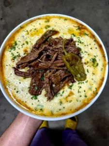 Mississippi pot roast served with jalapeno cheddar grits on a plate