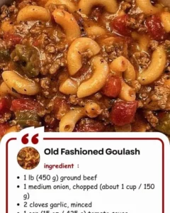 Delicious bowl of Old Fashioned Goulash served with herbs and fresh vegetables