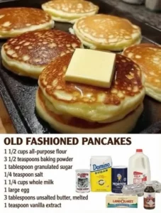 Stack of fluffy old fashioned pancakes with syrup and berries