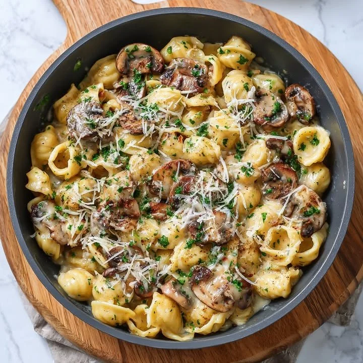 Creamy Garlic Mushroom Alfredo Pasta in a bowl, garnished with parsley.