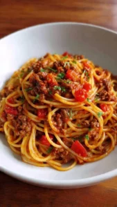 One-pot taco spaghetti dish served with cheese and herbs