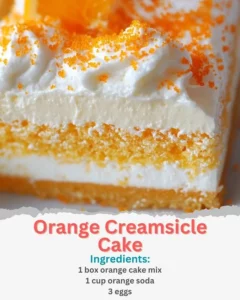Slice of Orange Creamsicle Cake with orange slices and cream frosting