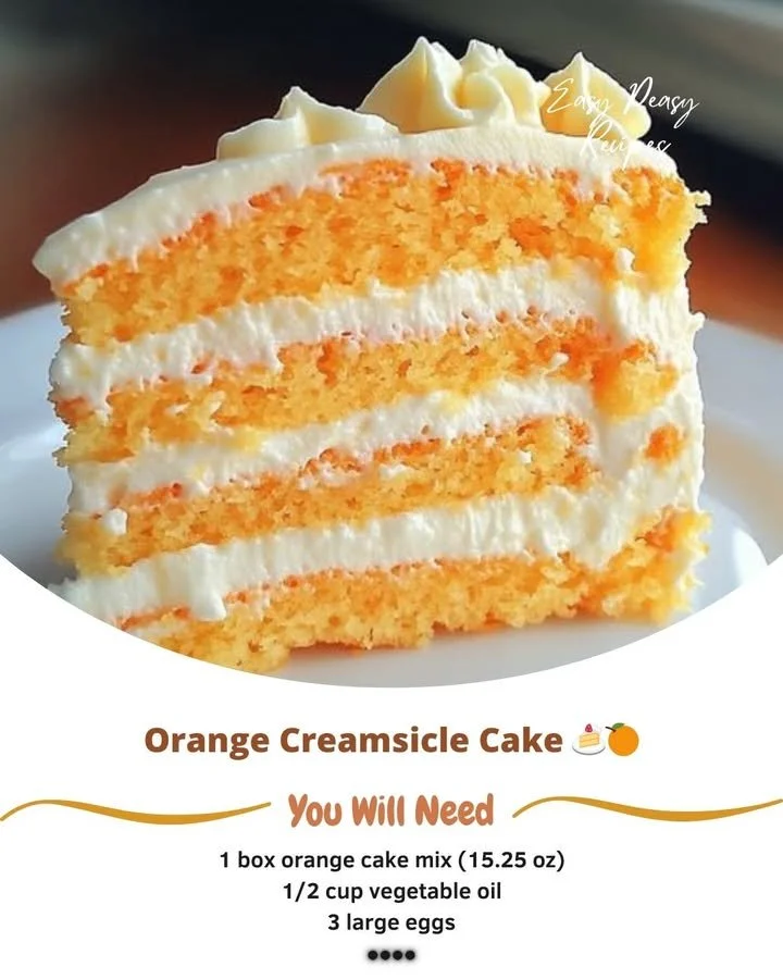 Delicious Orange Creamsicle Cake topped with whipped cream and orange slices.