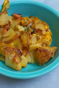 Oven fried potatoes and onions served in a rustic dish