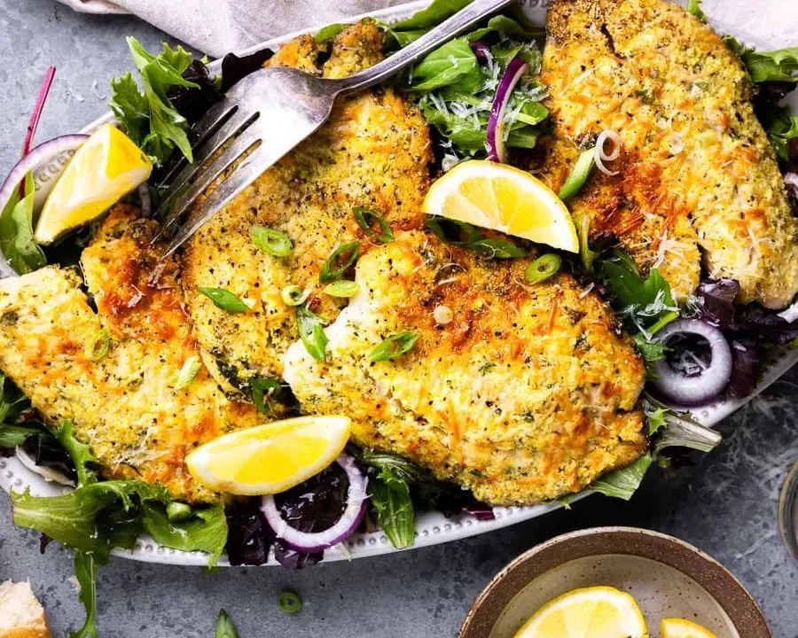 Parmesan Crusted Tilapia on a plate garnished with herbs