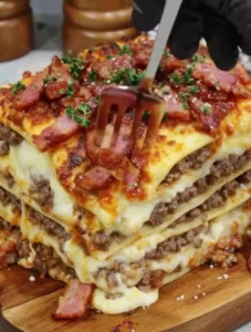 Parmesan garlic bacon cheeseburger lasagna layered with cheesy goodness and crisp bacon