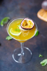 Refreshing passion fruit cocktail garnished with mint and served in a glass