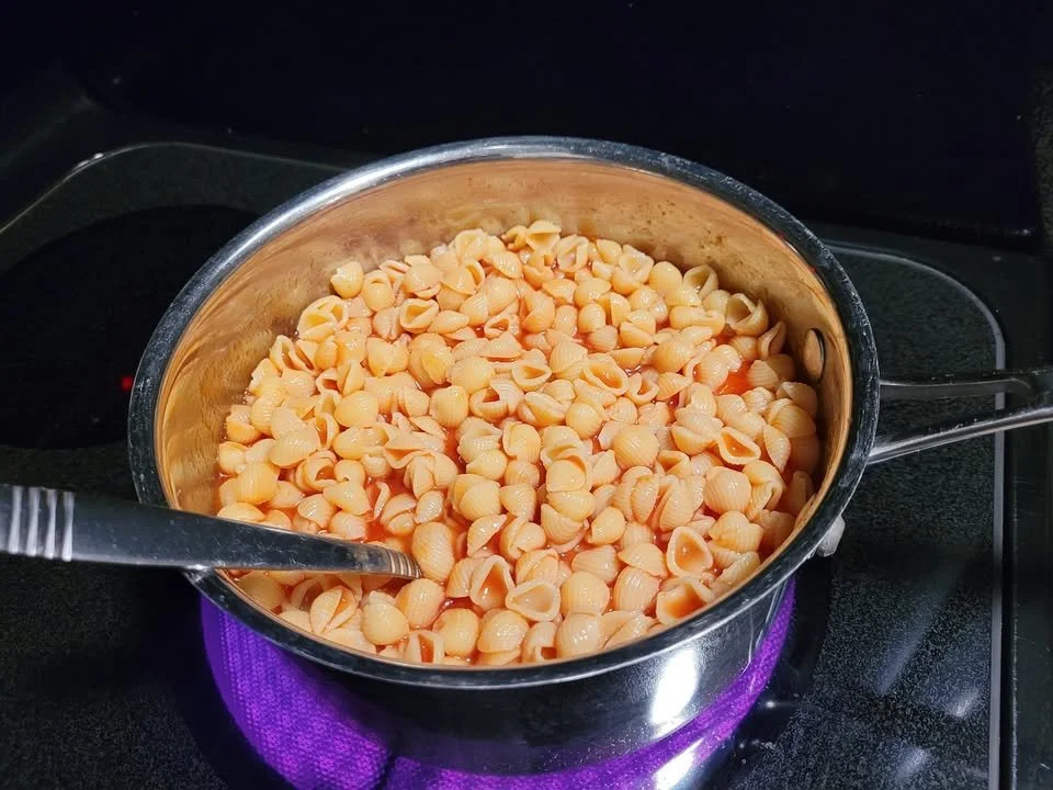 Pasta shells cooked in rich tomato juice served in a bowl