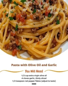 Pasta with olive oil and garlic served in a bowl, garnished with parsley.