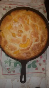 Delicious homemade peach cobbler with golden crust and fresh peach filling