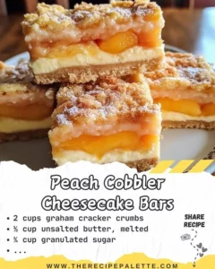 Delicious Peach Cobbler Cheesecake Bars topped with fresh peaches.