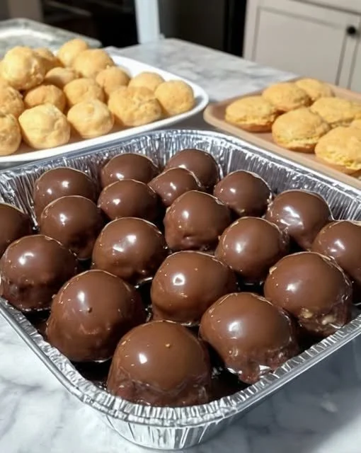 Homemade peanut butter balls topped with chocolate and nuts.