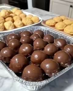 A plate of homemade Peanut Butter Balls with chocolate coating and nuts