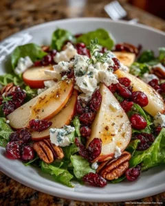 Pear, apple, and cranberry winter salad with whipped goat cheese snowflakes