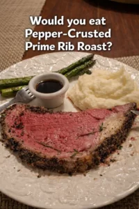Pepper-Crusted Prime Rib Roast garnished with herbs and spices, ready to serve
