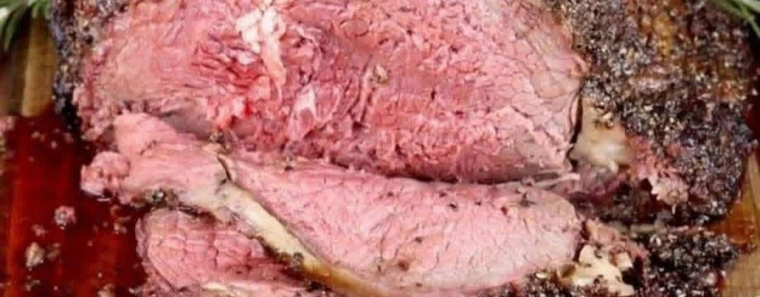 Pepper Parmesan Prime Rib served with sides on a plate