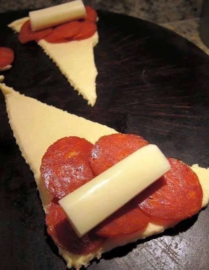 Plate of freshly baked pepperoni crescent rolls ready to serve.