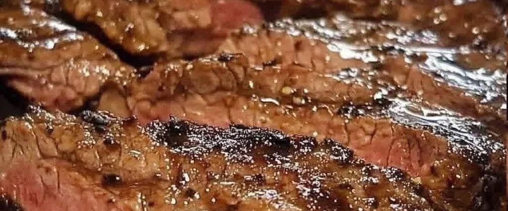 Juicy and tender pan seared steak on a plate, cooked to perfection.