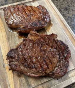 Juicy perfectly cooked steak on a plate garnished with herbs
