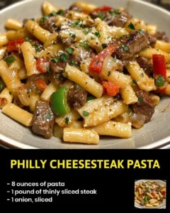 Philly Cheesesteak Pasta with melted cheese and beef on a plate