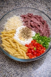 Delicious Philly Cheesesteak Pasta dish topped with melted cheese and peppers.