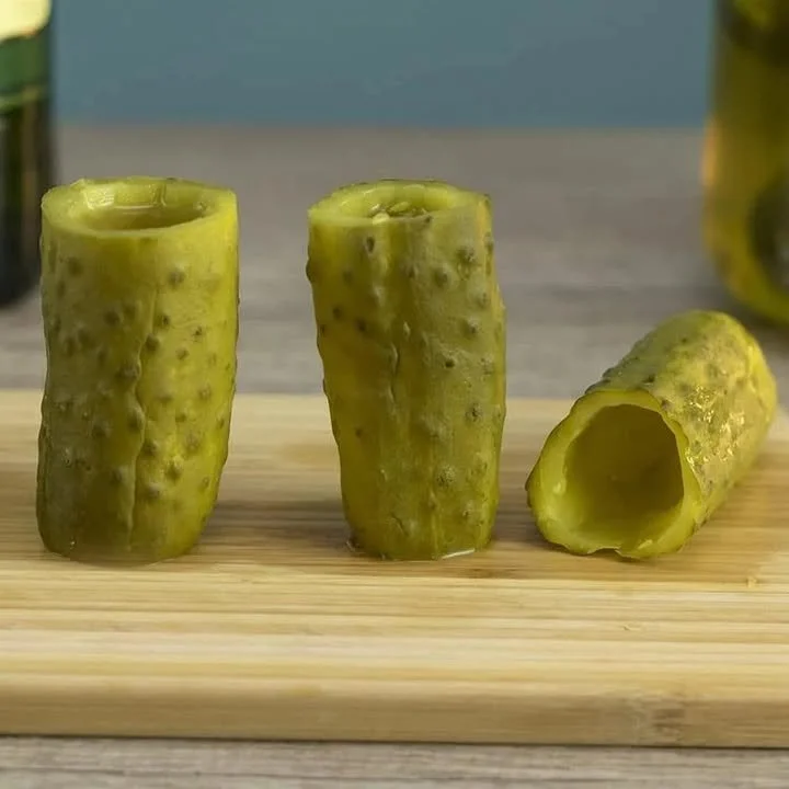 A fun display of pickle back shots served with pickles for a unique cocktail experience.