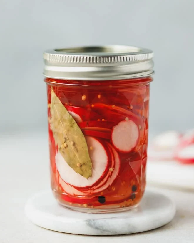 Jar of vibrant pickled radishes ready to enhance your dishes