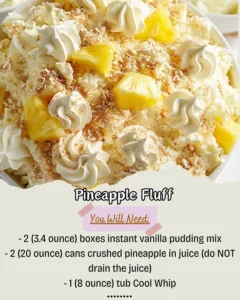 A delicious serving of Pineapple Fluff dessert with whipped cream and pineapple chunks.