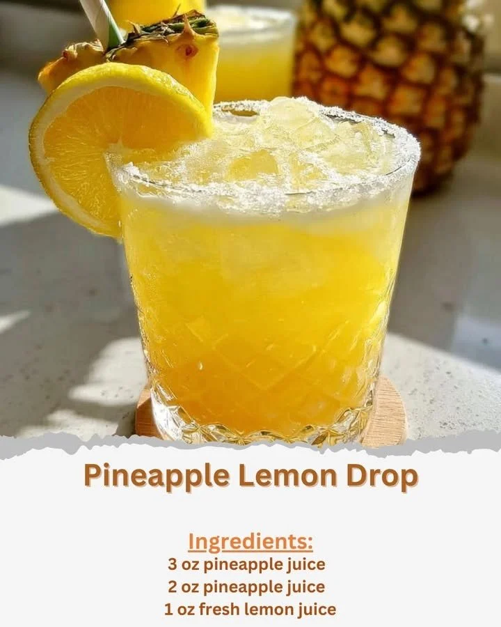 Pineapple Lemon Drop cocktail in a glass with a slice of pineapple and lemon garnish
