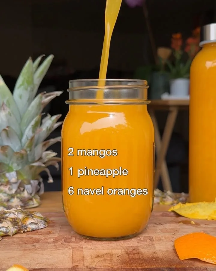 A refreshing glass of Pineapple Mango Orange Juice garnished with fresh fruit.