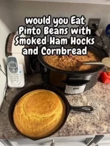 Bowl of pinto beans with smoked ham hocks and a side of cornbread