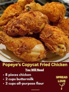 A plate of crispy Popeye's CopyCat Fried Chicken garnished with fresh herbs.