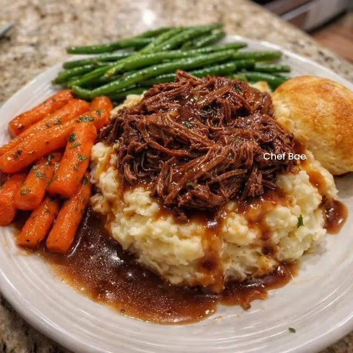 Tender pot roast with rich gravy served on a plate