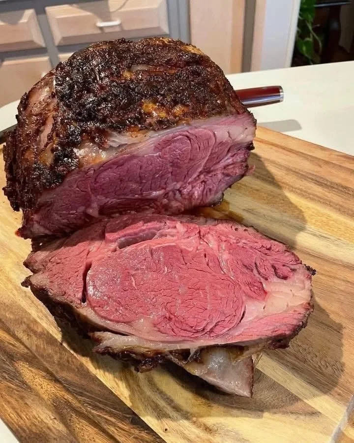 Juicy prime rib roast cooked to perfection, served with herbs and sides.