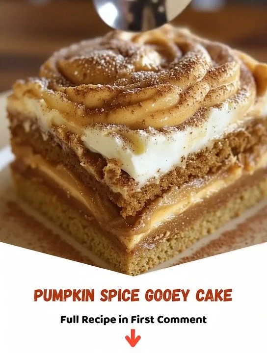 Slice of pumpkin spice gooey cake topped with cream frosting and spices