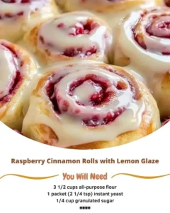 Raspberry cinnamon rolls drizzled with lemon glaze on a plate