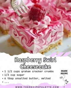 Delicious slice of Raspberry Swirl Cheesecake topped with fresh raspberries