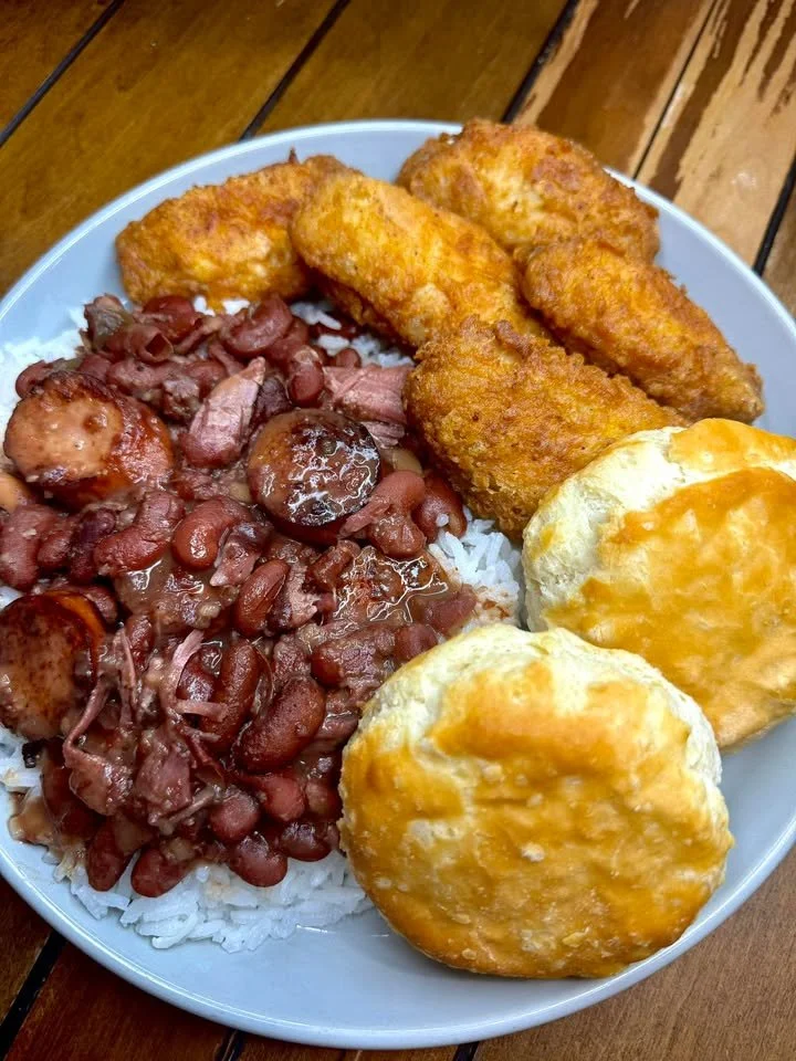 Bowl of red beans and rice served with crispy fried chicken wings.