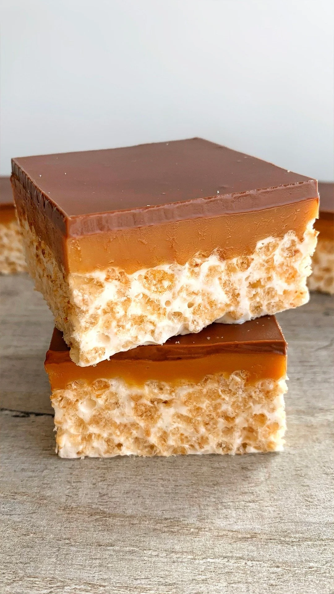 Delicious Rice Krispy Millionaires Bars topped with chocolate and caramel.