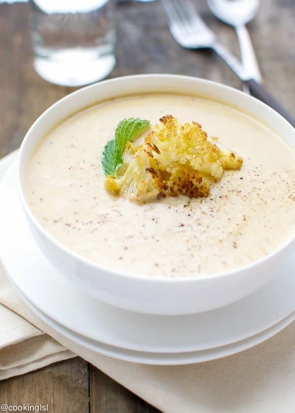 Creamy roasted cauliflower and Boursin soup served in a bowl