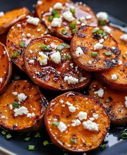 Delicious roasted sweet potato rounds drizzled with honey and sprinkled with feta cheese.