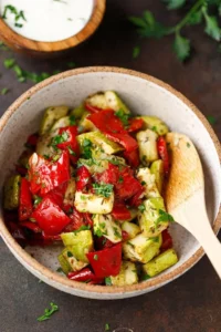 Roasted zucchini and peppers dish served on a plate