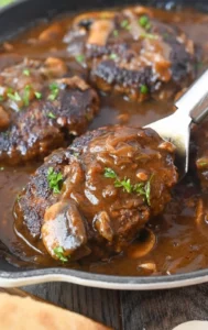 Delicious homemade Salisbury steak served with gravy and vegetables