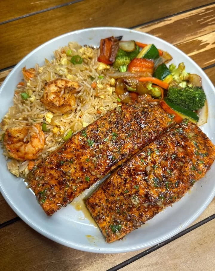 Delicious Salmon and Shrimp Fried Rice served in a bowl with fresh vegetables