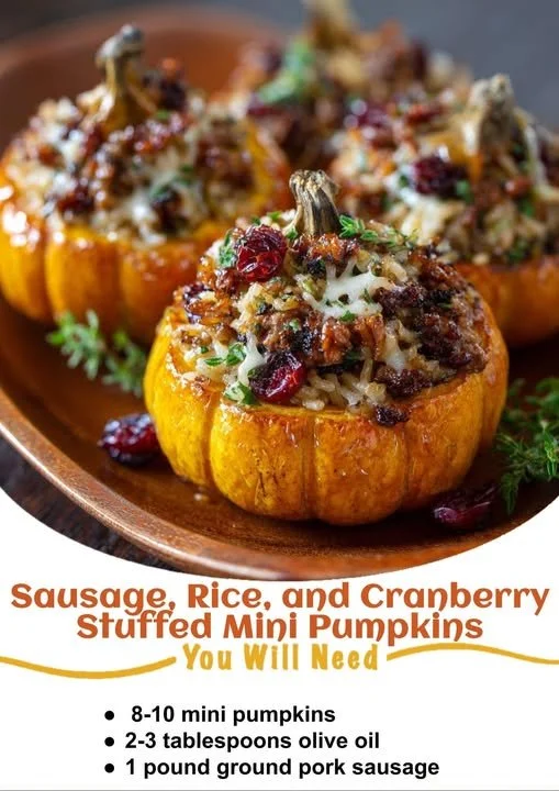 Sausage, rice, and cranberry stuffed mini pumpkins on a wooden table.