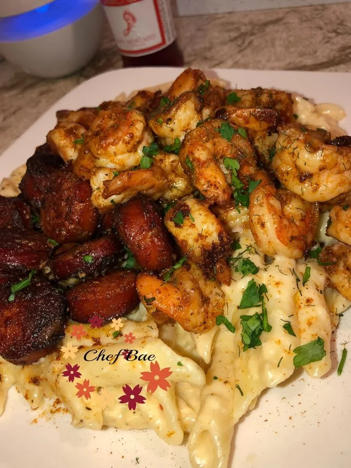 Delicious Sausage Shrimp Alfredo pasta dish topped with herbs